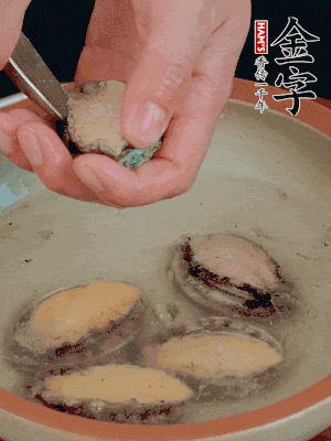 鮑魚加鹽、清水浸泡，用勺子挖出鮑魚肉。